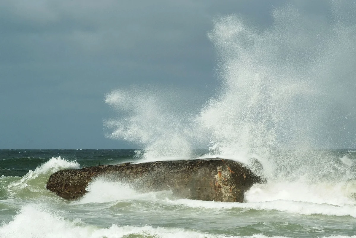 welle kracht über bunker am strand kurze belichtungszeit